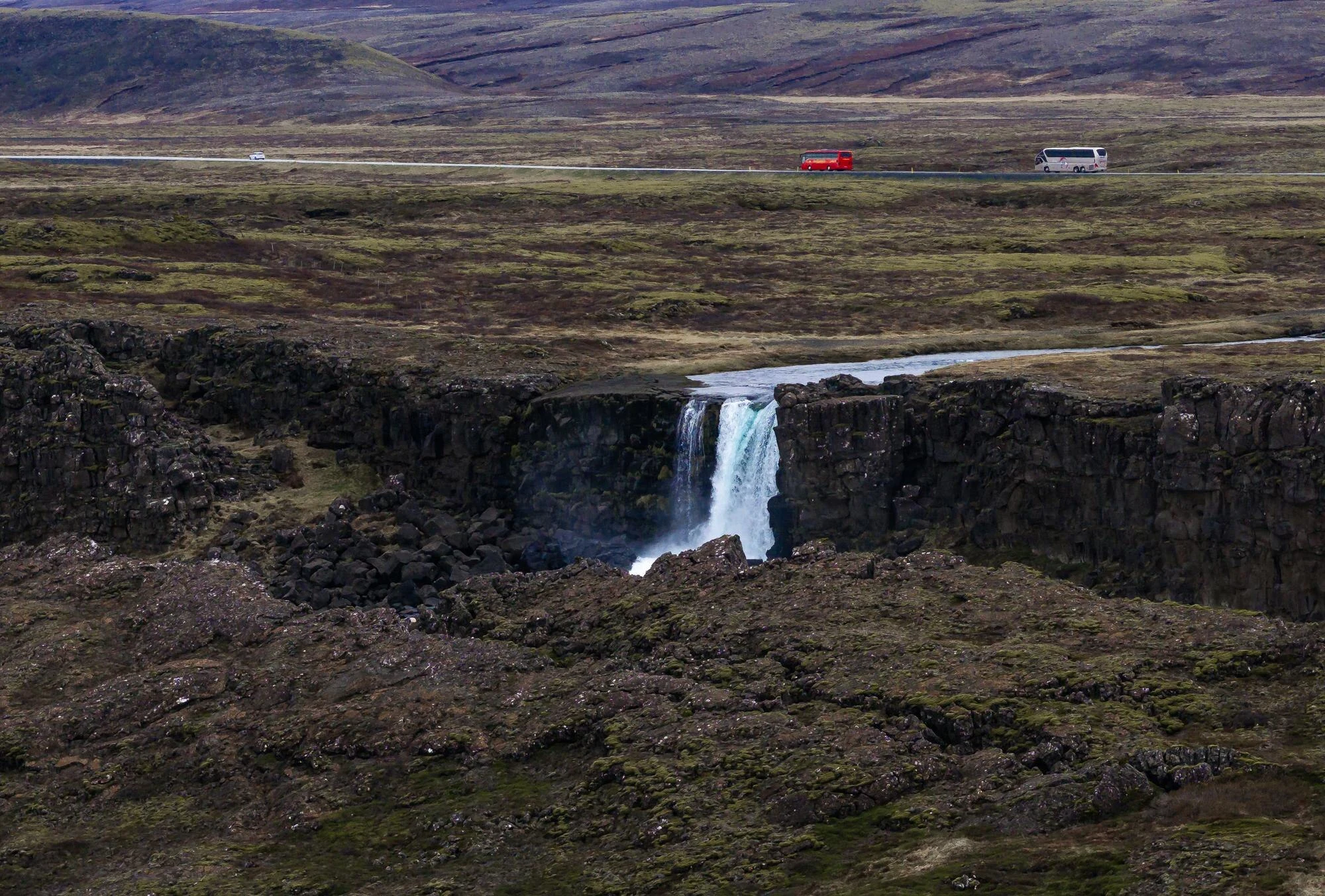 Öxarárfoss waterfall beside a marked trail at Þingvellir.