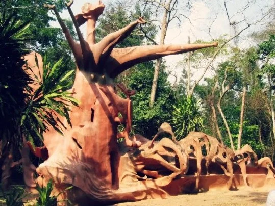 Monumental sculpture surrounded by forest in the Osun-Osogbo Sacred Grove.