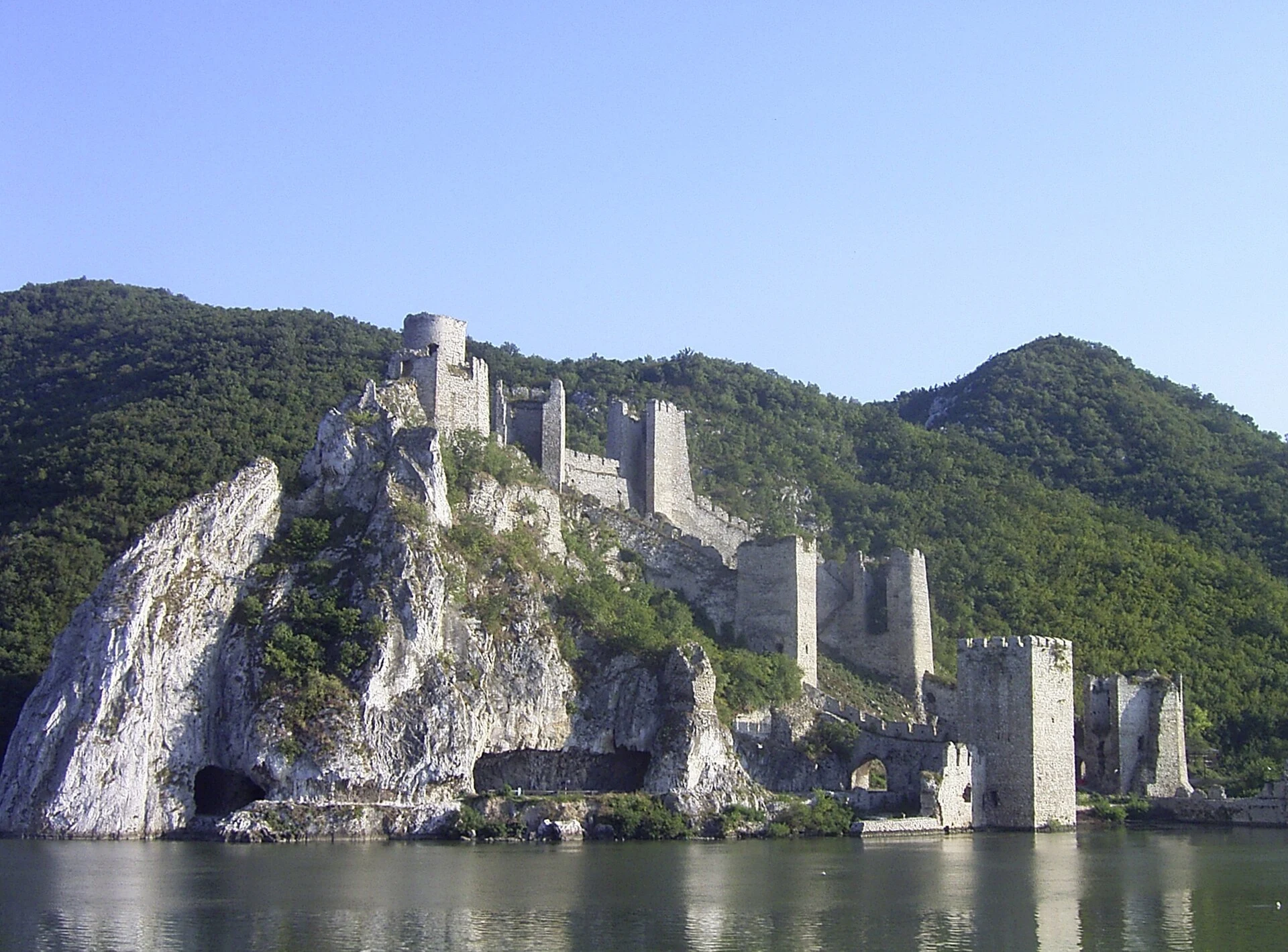 Stone towers and walls of Golubac Fortress beside the Danube.