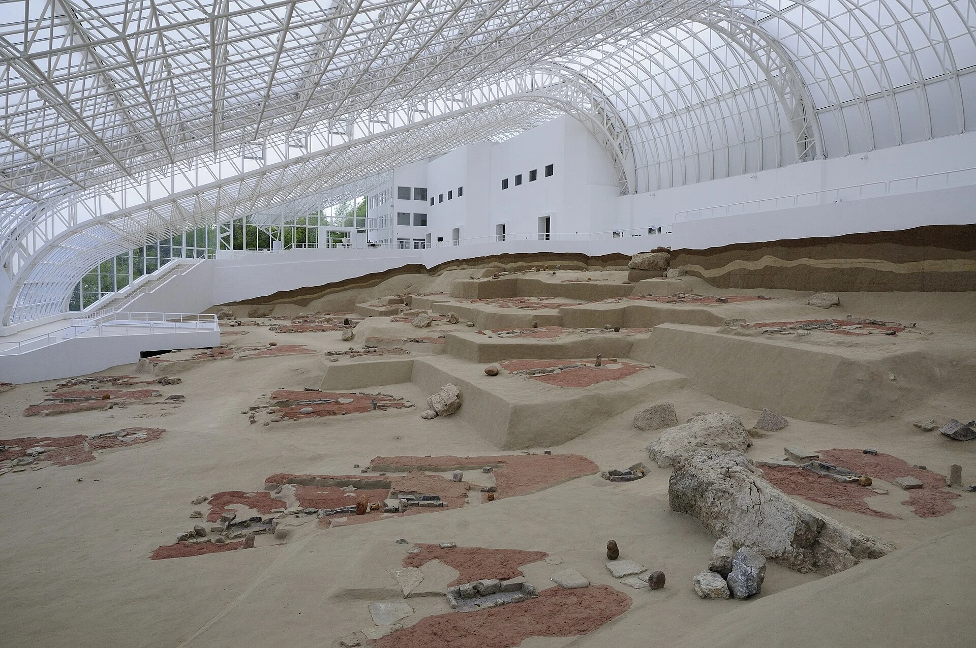 Trapezoidal house remains beneath the protective structure at Lepenski Vir.