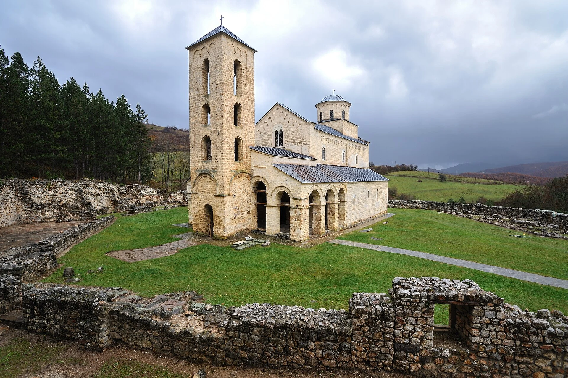 Exterior of Sopoćani Monastery church in a wooded setting.