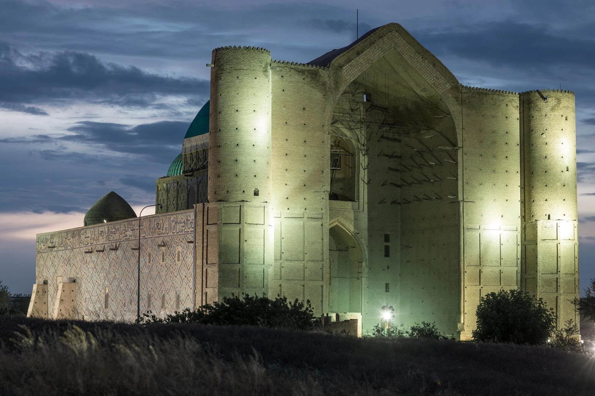 Exterior of the Khoja Ahmed Yasawi Mausoleum in Turkistan at dawn.