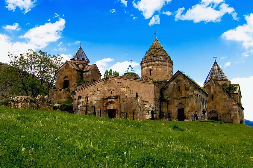 Stone architecture and khachkar at Goshavank Monastery, Armenia.