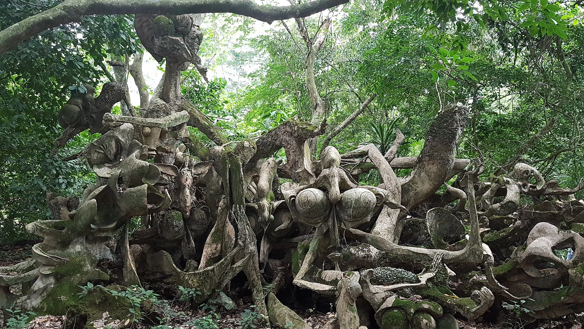 Sacred sculpture among vegetation in Osun-Osogbo Sacred Grove.