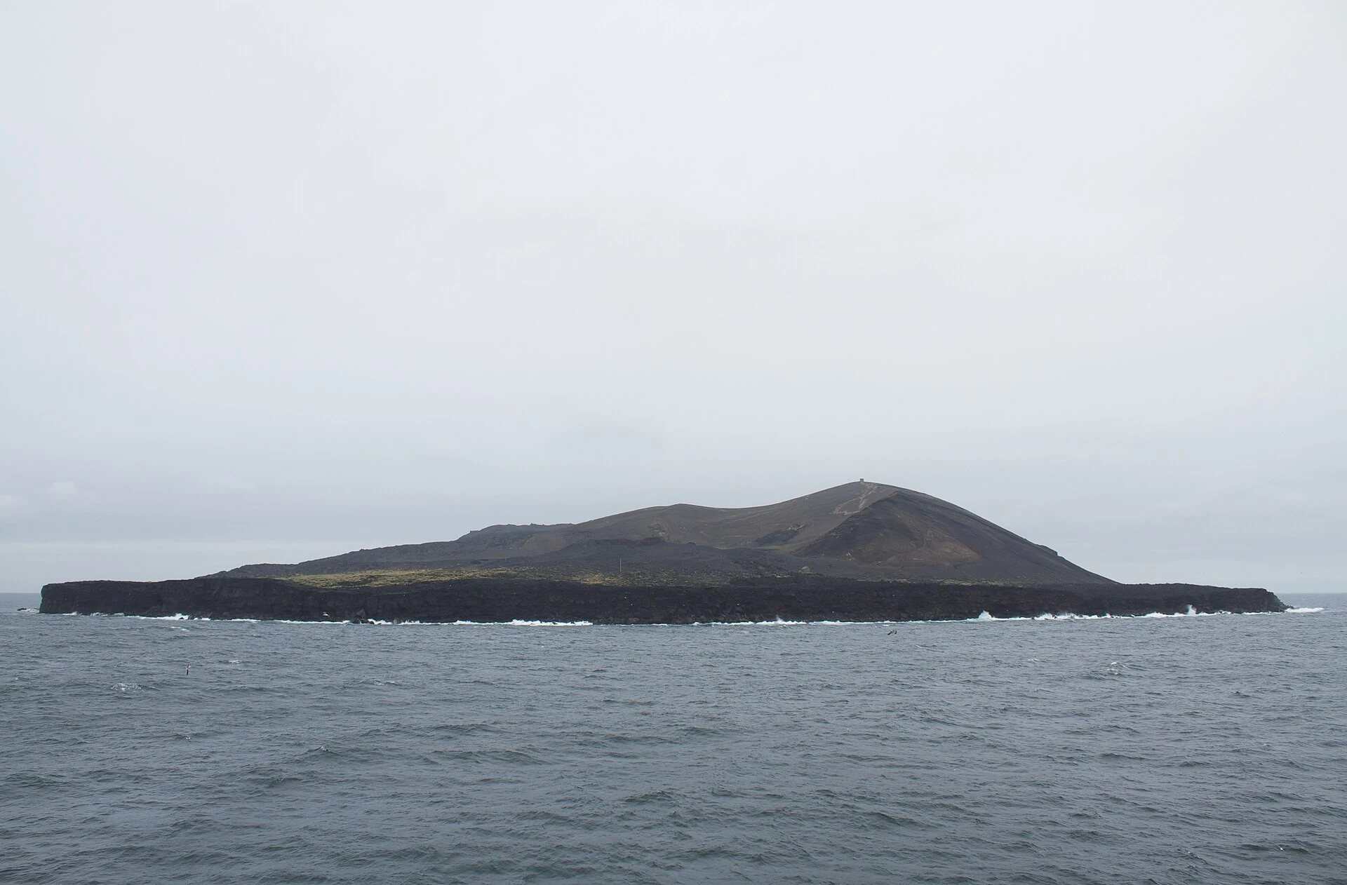 Protected volcanic island of Surtsey seen from sea or air.