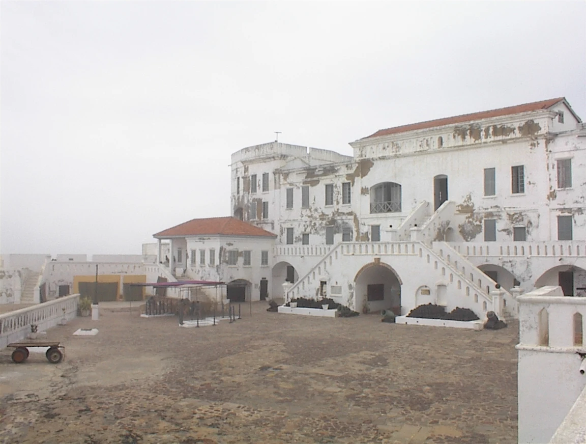 White ramparts of Cape Coast Castle facing the Atlantic in Ghana.