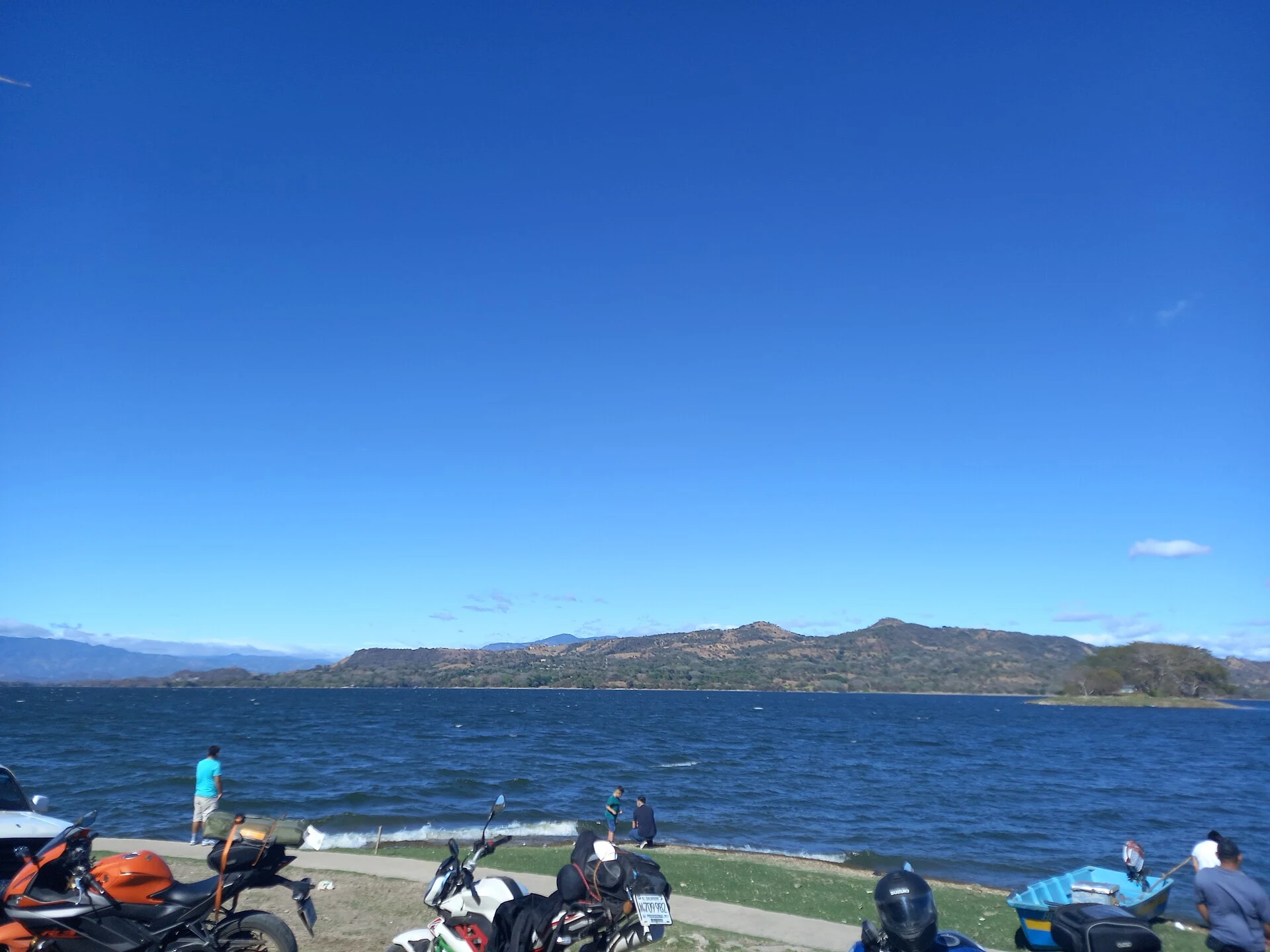 Boat and shoreline vegetation on Lake Suchitlán, part of the Cerrón Grande reservoir.