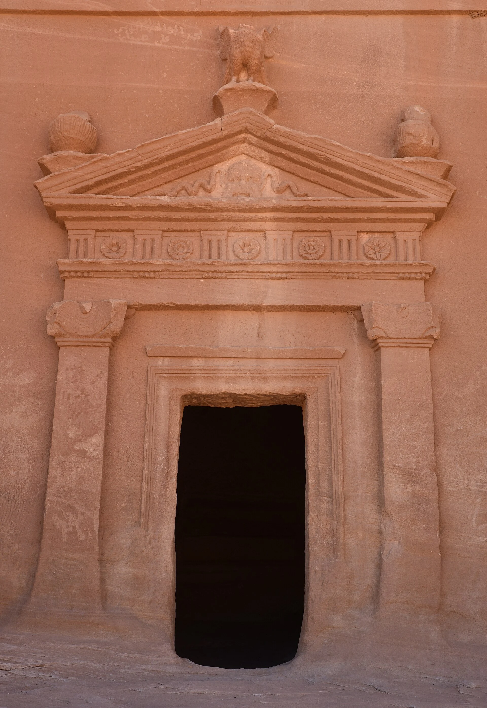 Nabataean tomb facade carved in sandstone at Hegra.