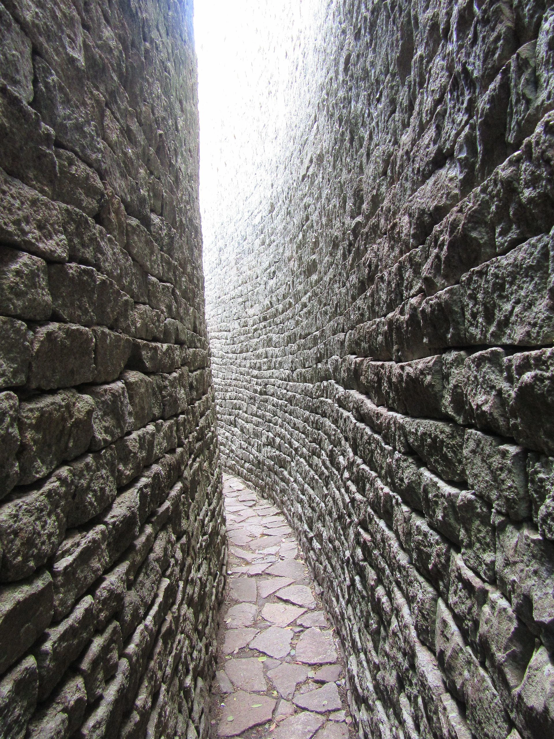 Curving wall and conical tower of Great Zimbabwe’s Great Enclosure at dawn.