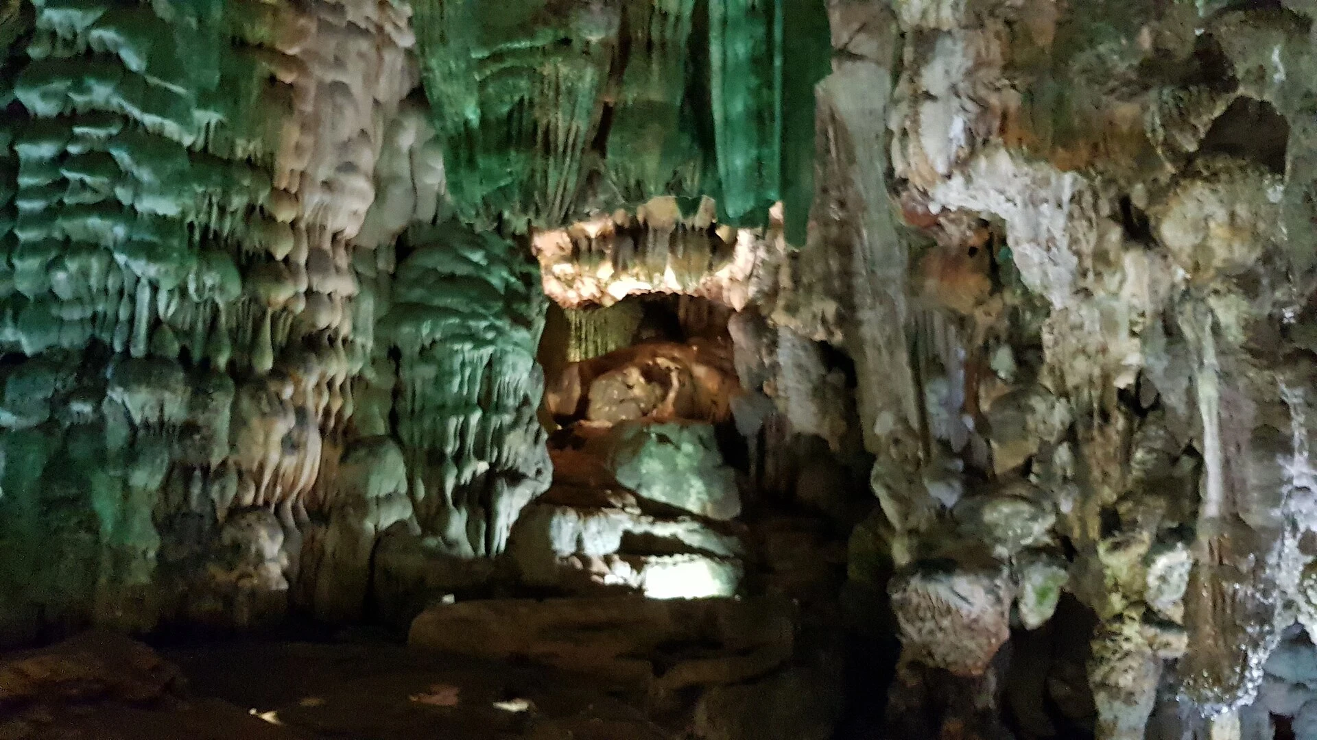 Wooden walkway among limestone formations in Paradise Cave.