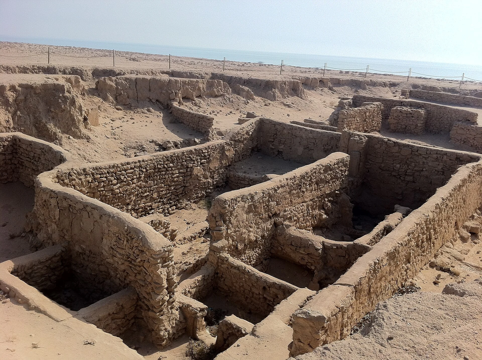 Dirt path and discreet ruins in Failaka’s cultural landscape.