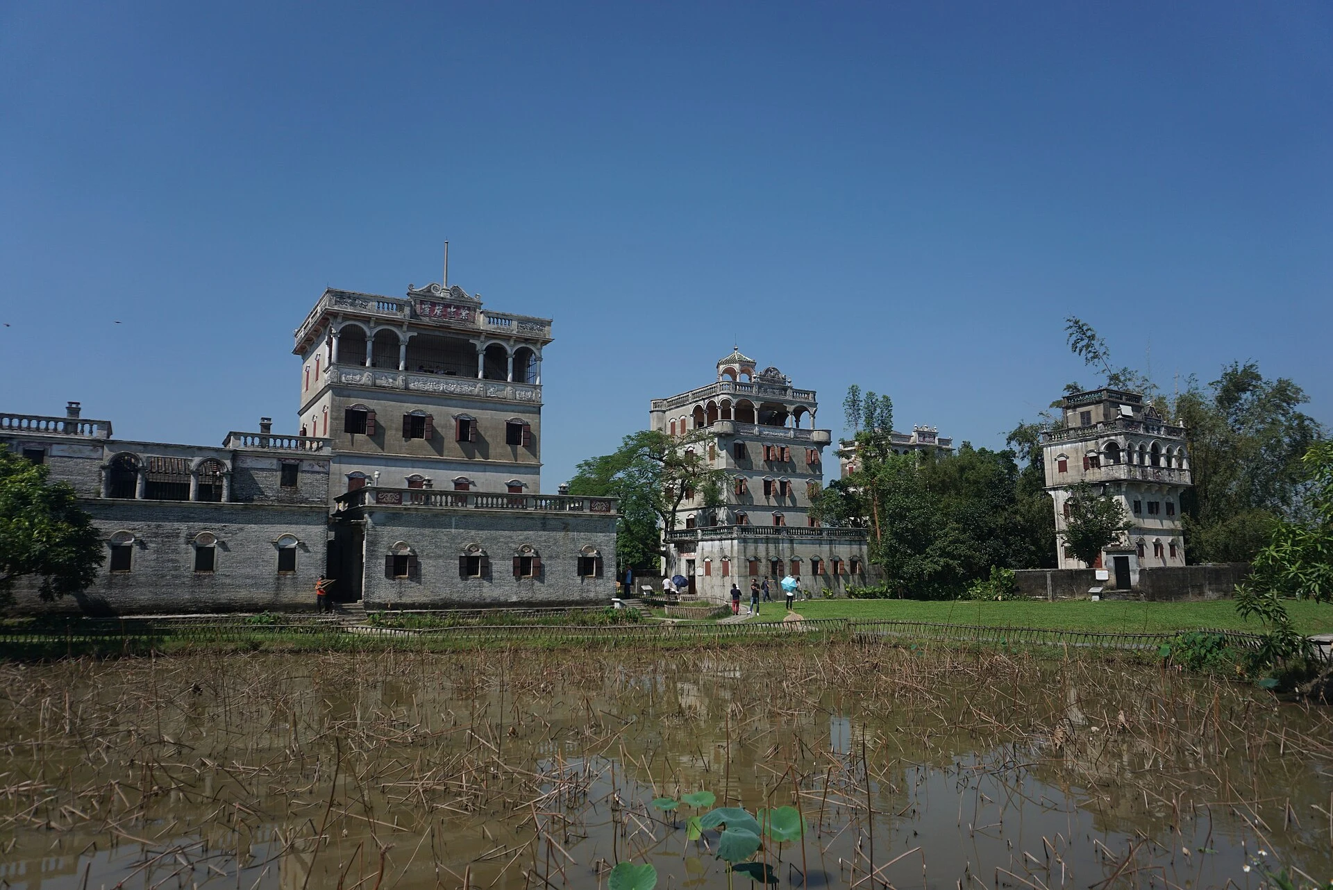 Diaolou tower beside rice fields and a pond in Zili, Kaiping
