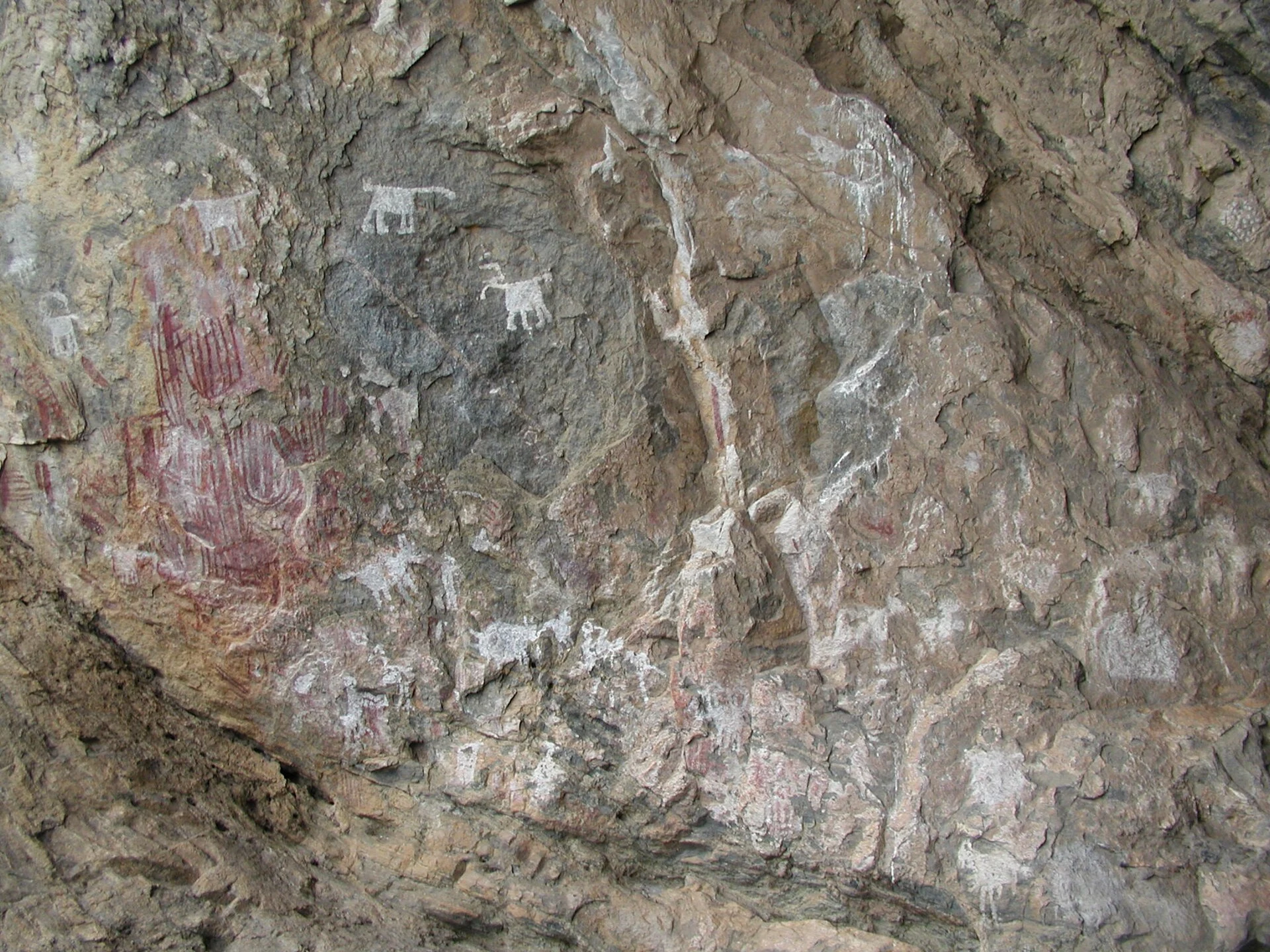 Respectful close view of red and white rock paintings on granite at Chongoni.