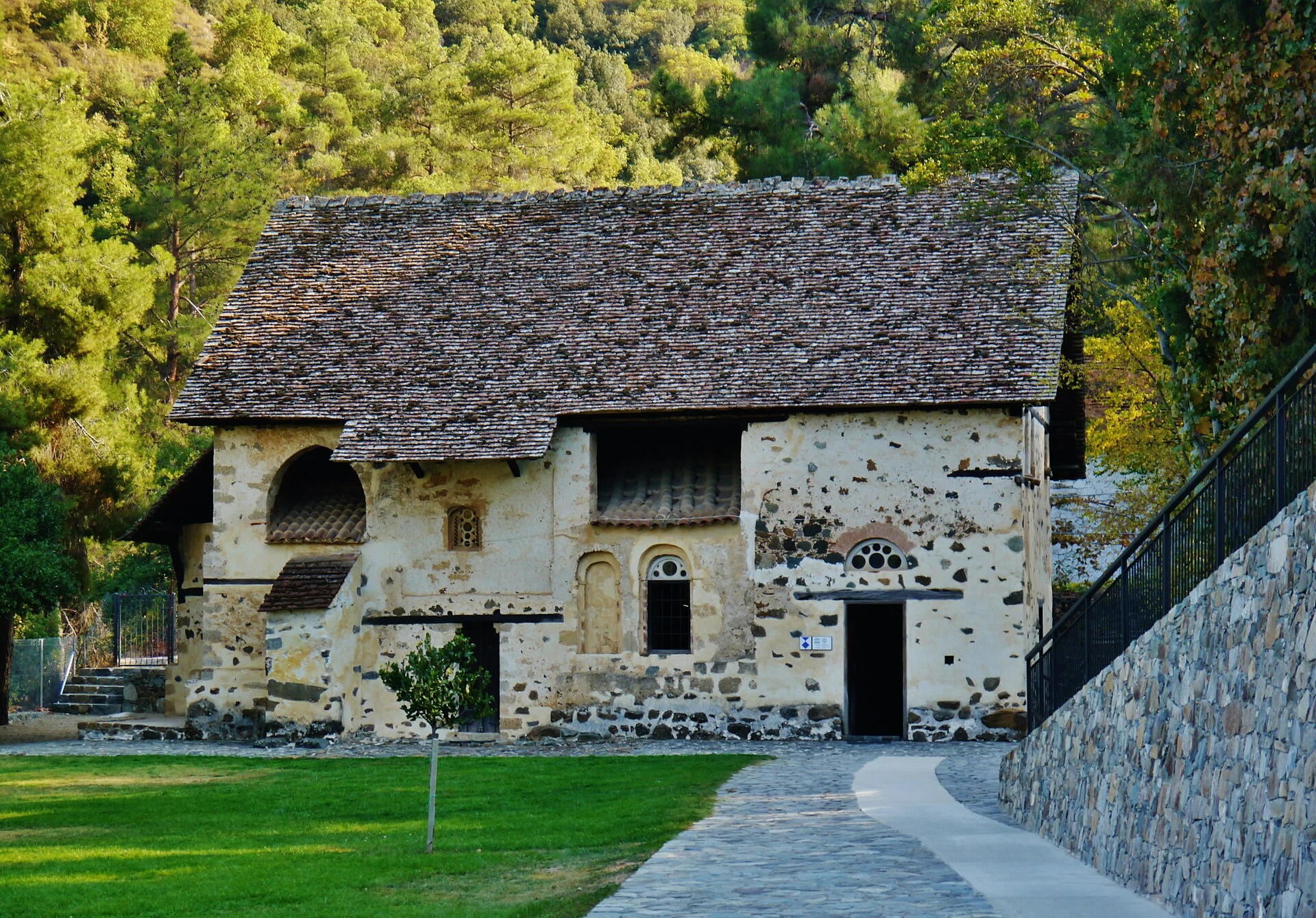 Exterior of Agios Nikolaos tis Stegis with its steep timber roof in the Solea Valley.